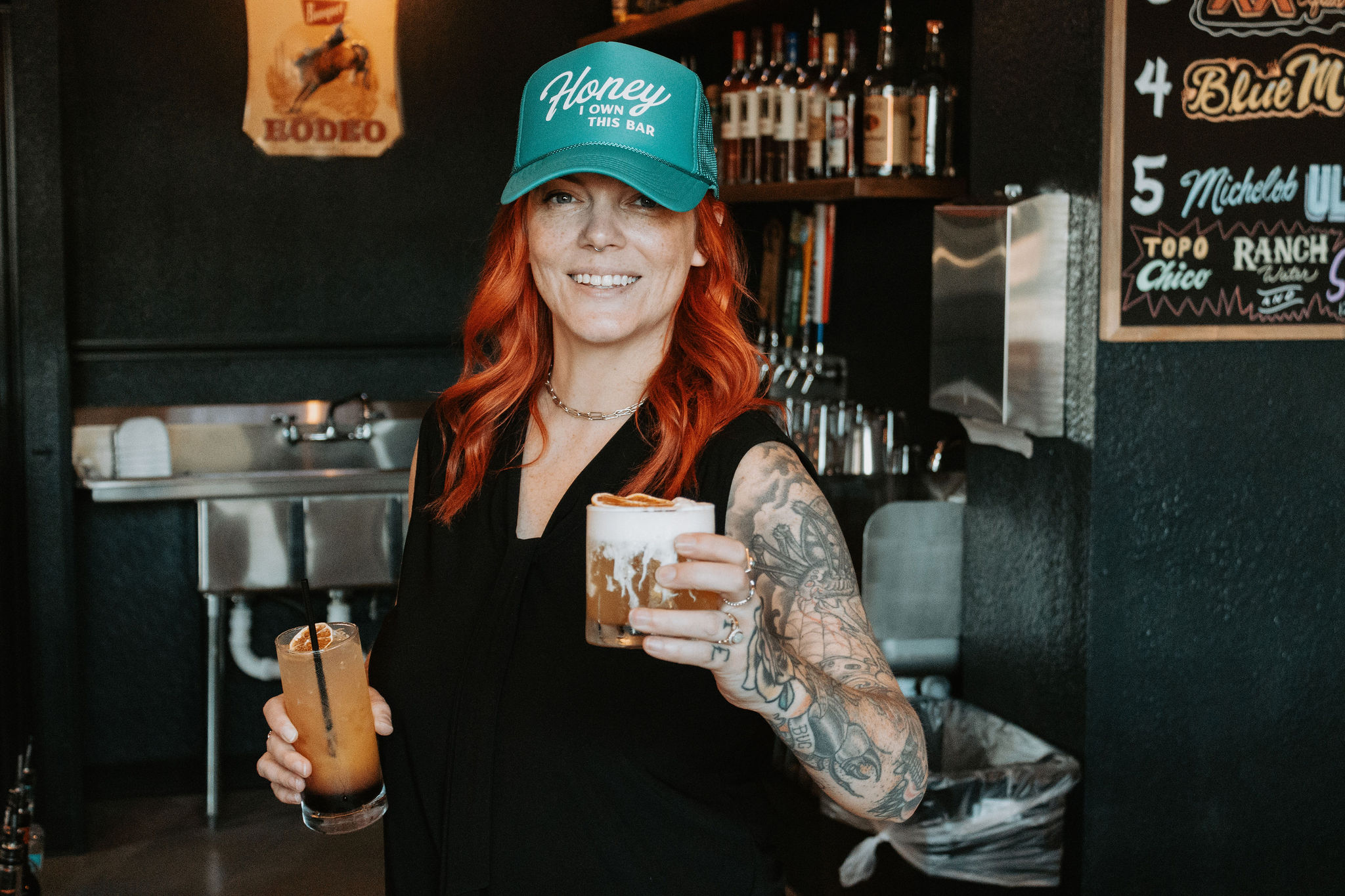A bartender serving up two fresh cocktails at Reds Crafted Cocktails